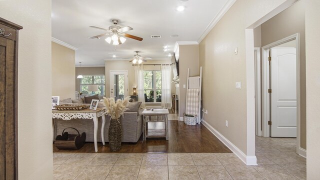 554 Magnolia Lake Dr, Defuniak Springs, FL 32433 - living room with ceiling fan, crown molding, baseboards, and light tile patterned floors