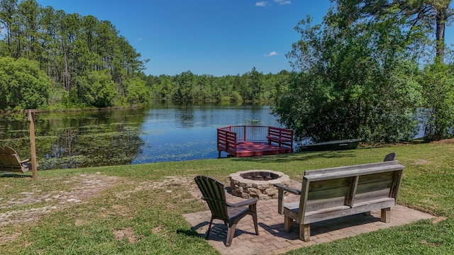 554 Magnolia Lake Dr, Defuniak Springs, FL 32433 - view of green lawn featuring an outdoor fire pit, a water view, and a wooded view