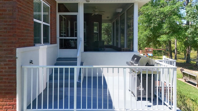 554 Magnolia Lake Dr, Defuniak Springs, FL 32433 - deck featuring a sunroom and ceiling fan