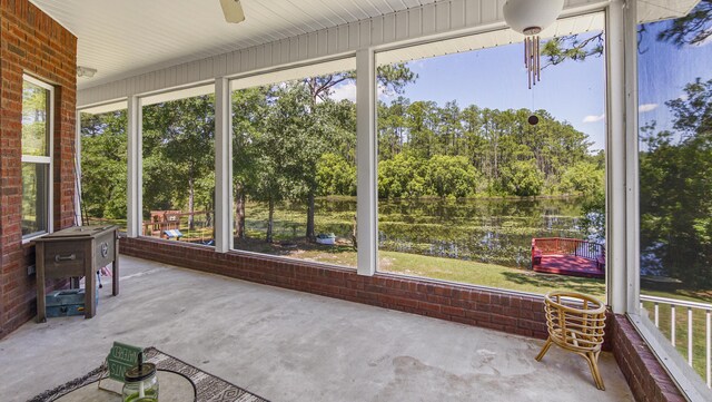 554 Magnolia Lake Dr, Defuniak Springs, FL 32433 - unfurnished sunroom with view of wooded area, ceiling fan, and plenty of natural light