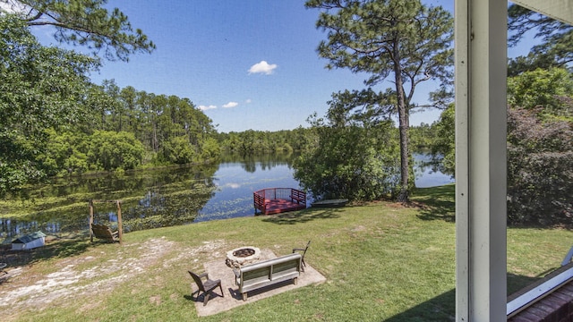 554 Magnolia Lake Dr, Defuniak Springs, FL 32433 - view of green lawn with a water view and an outdoor fire pit