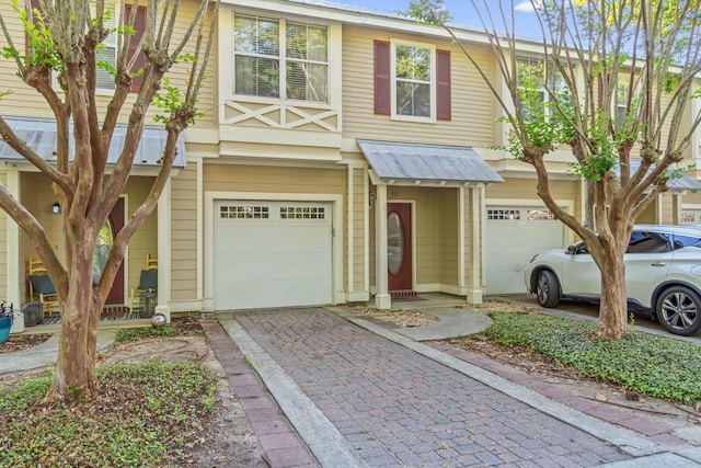387 Twin Lakes Ln, Destin, FL 32541 - townhome / multi-family property featuring a garage, driveway, and metal roof