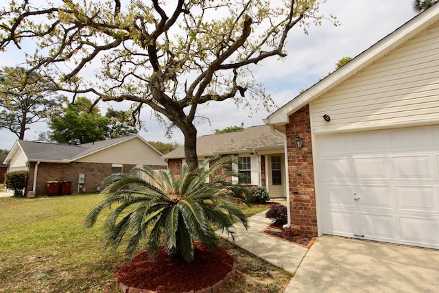206 Secretariat Dr, Crestview, FL 32539 - view of front of home with concrete driveway, brick siding, an attached garage, and a front yard