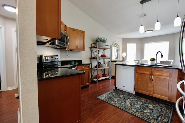 206 Secretariat Dr, Crestview, FL 32539 - kitchen featuring brown cabinets, stainless steel appliances, a sink, and dark wood-style flooring