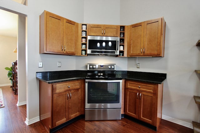 206 Secretariat Dr, Crestview, FL 32539 - kitchen with stainless steel appliances, open shelves, dark wood finished floors, and baseboards
