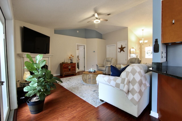 206 Secretariat Dr, Crestview, FL 32539 - living room with ceiling fan with notable chandelier, lofted ceiling, dark wood-style floors, and a fireplace