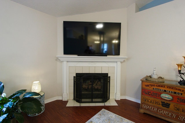 206 Secretariat Dr, Crestview, FL 32539 - interior space with baseboards, vaulted ceiling, wood finished floors, and a tile fireplace