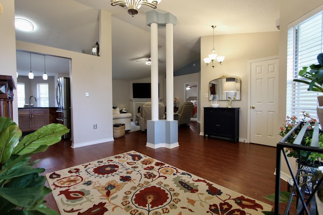 206 Secretariat Dr, Crestview, FL 32539 - bedroom with a fireplace, dark wood finished floors, high vaulted ceiling, freestanding refrigerator, and an inviting chandelier