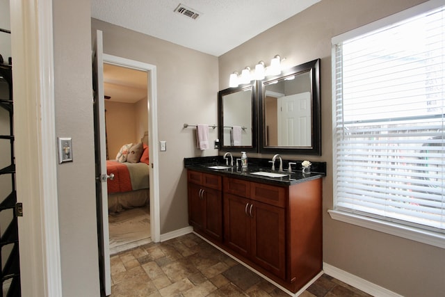 206 Secretariat Dr, Crestview, FL 32539 - ensuite bathroom with double vanity, visible vents, a sink, baseboards, and ensuite bathroom