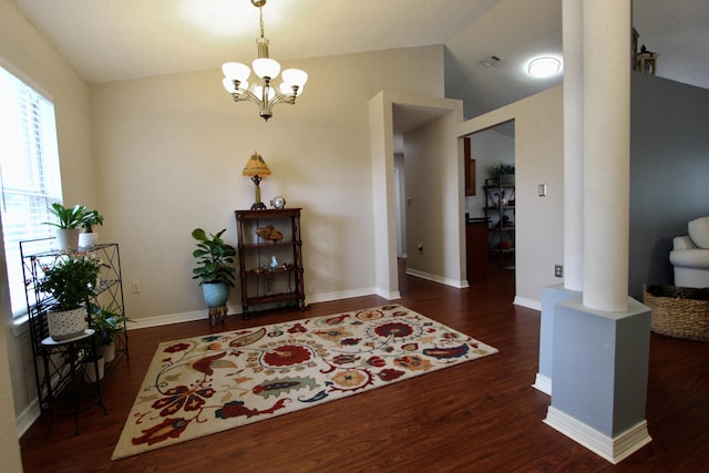 206 Secretariat Dr, Crestview, FL 32539 - foyer entrance featuring an inviting chandelier, decorative columns, wood finished floors, and lofted ceiling