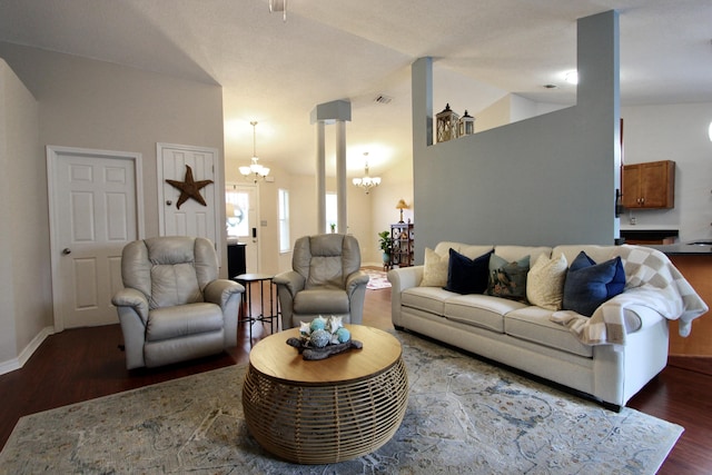 206 Secretariat Dr, Crestview, FL 32539 - living area with an inviting chandelier, visible vents, wood finished floors, baseboards, and vaulted ceiling