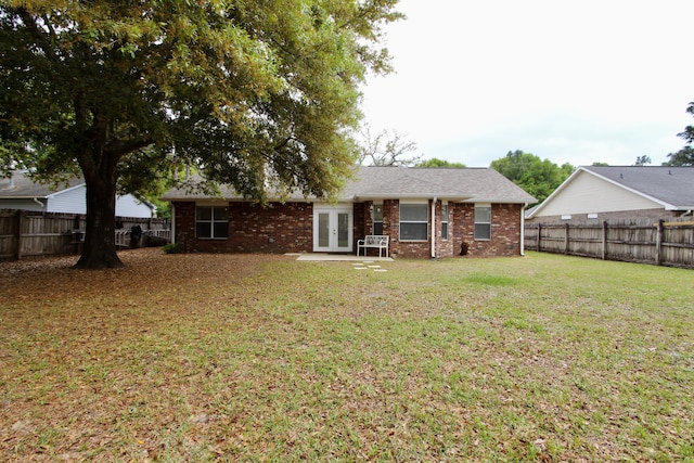 206 Secretariat Dr, Crestview, FL 32539 - rear view of property featuring a yard, brick siding, french doors, and a fenced backyard