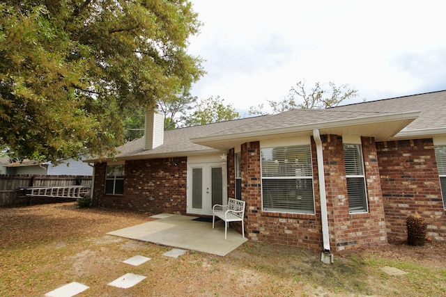 206 Secretariat Dr, Crestview, FL 32539 - back of property featuring fence, french doors, a chimney, brick siding, and a patio area