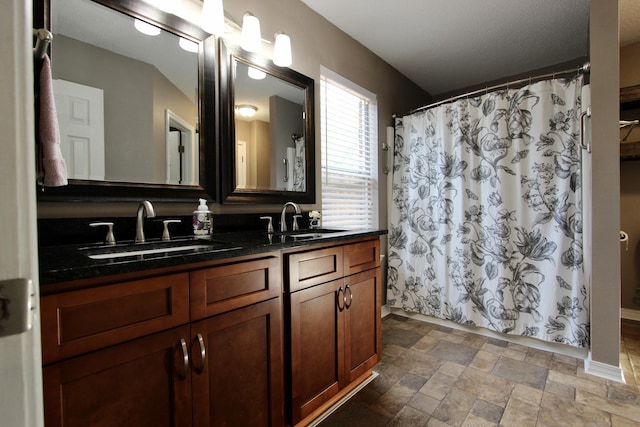 206 Secretariat Dr, Crestview, FL 32539 - full bath featuring double vanity, stone finish floor, curtained shower, and a sink