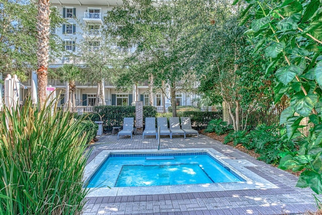 view of swimming pool with fence
