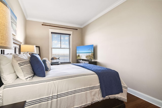 bedroom with ornamental molding, wood finished floors, and baseboards