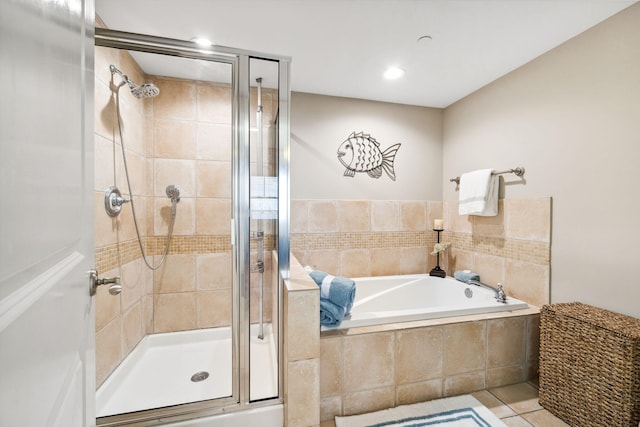 bathroom with a shower stall, a garden tub, and tile patterned floors
