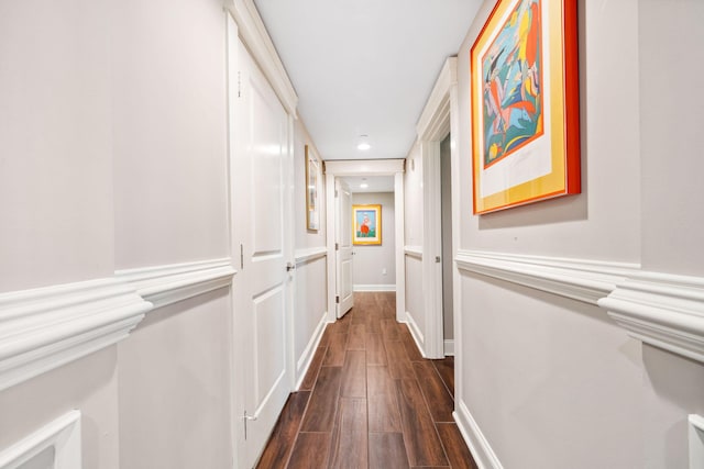 hallway featuring dark wood finished floors, baseboards, and recessed lighting