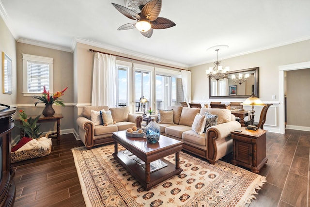 living room with baseboards, a ceiling fan, dark wood finished floors, a chandelier, and ornamental molding