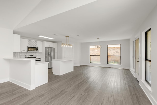 197 Kel-Wen Circle Kel-Wen, Destin, FL 32541 - kitchen with stainless steel appliances, light countertops, wood finished floors, and backsplash