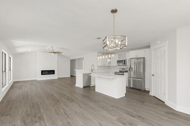 197 Kel-Wen Circle Kel-Wen, Destin, FL 32541 - kitchen featuring stainless steel appliances, a sink, light countertops, open floor plan, and a chandelier