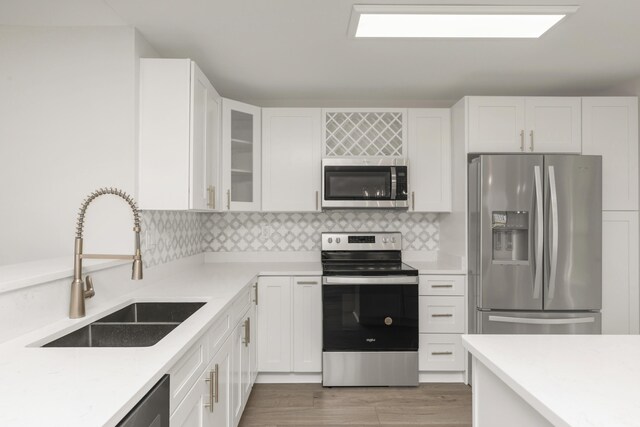 197 Kel-Wen Circle Kel-Wen, Destin, FL 32541 - kitchen with stainless steel appliances, a sink, white cabinetry, and light countertops
