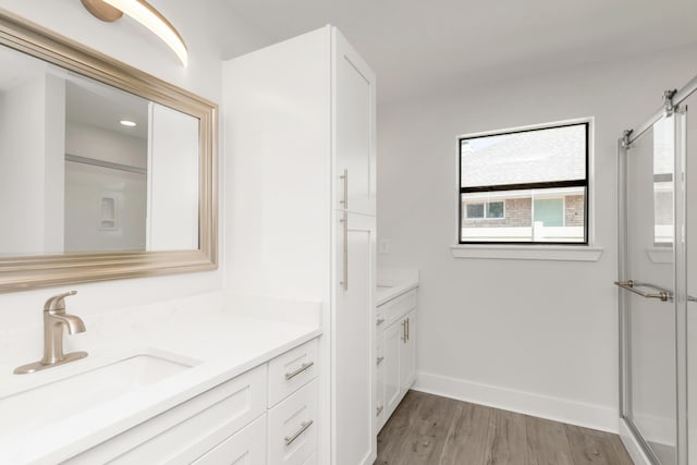 197 Kel-Wen Circle Kel-Wen, Destin, FL 32541 - bathroom featuring vanity, wood finished floors, a shower with shower door, and baseboards