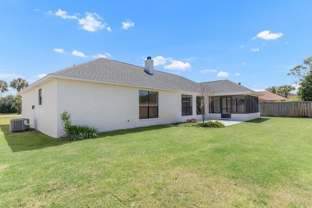 197 Kel-Wen Circle Kel-Wen, Destin, FL 32541 - rear view of property featuring a sunroom, central AC, brick siding, a chimney, and roof with shingles