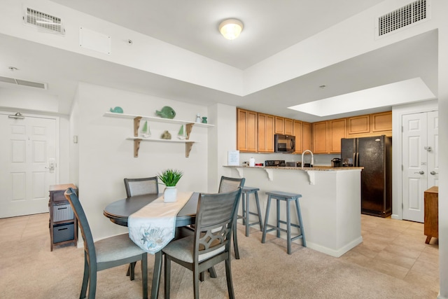 4203 Indian Bayou Trl Unit 1716, Destin, FL 32541 - dining space featuring visible vents, a tray ceiling, and light colored carpet