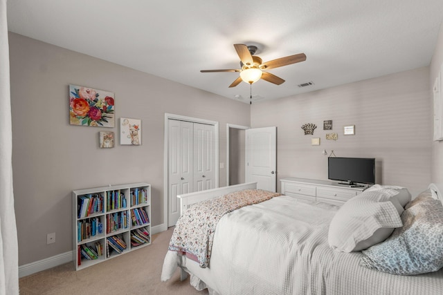 7045 Leisure St, Navarre, FL 32566 - bedroom with light carpet, a closet, baseboards, and ceiling fan