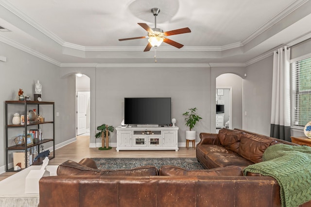 7045 Leisure St, Navarre, FL 32566 - living room featuring arched walkways, ceiling fan, wood finished floors, ornamental molding, and baseboards