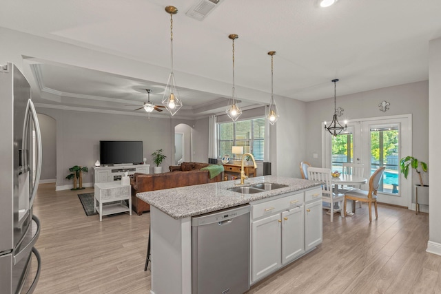 7045 Leisure St, Navarre, FL 32566 - kitchen featuring stainless steel appliances, a sink, light wood-type flooring, plenty of natural light, and ornamental molding