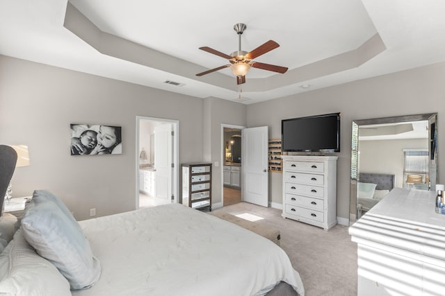 7045 Leisure St, Navarre, FL 32566 - bedroom with a raised ceiling, light colored carpet, connected bathroom, a ceiling fan, and baseboards