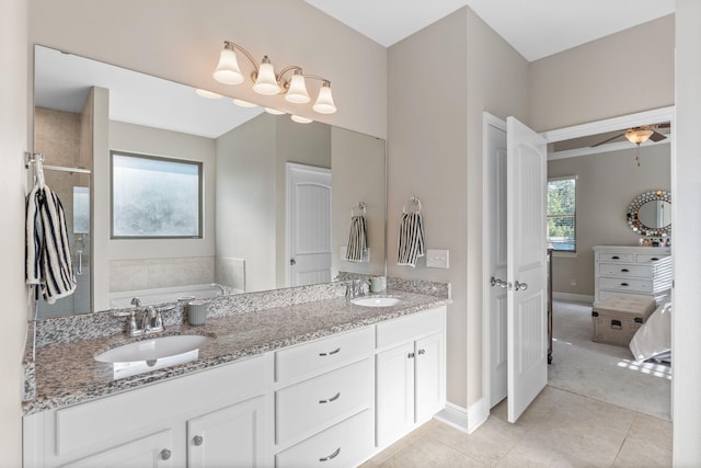 7045 Leisure St, Navarre, FL 32566 - full bathroom with a bath, tile patterned flooring, baseboards, and double vanity