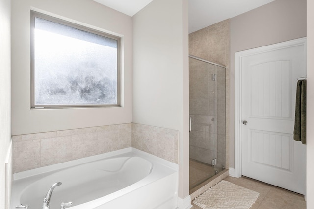 7045 Leisure St, Navarre, FL 32566 - bathroom with a shower stall, a garden tub, and tile patterned floors