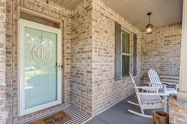 7045 Leisure St, Navarre, FL 32566 - property entrance featuring brick siding and covered porch