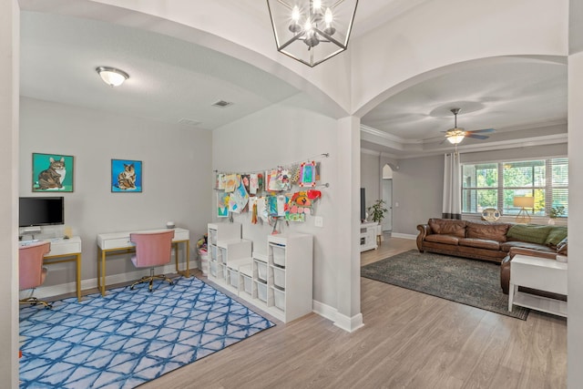 7045 Leisure St, Navarre, FL 32566 - interior space featuring arched walkways, wood finished floors, baseboards, ceiling fan, and a chandelier