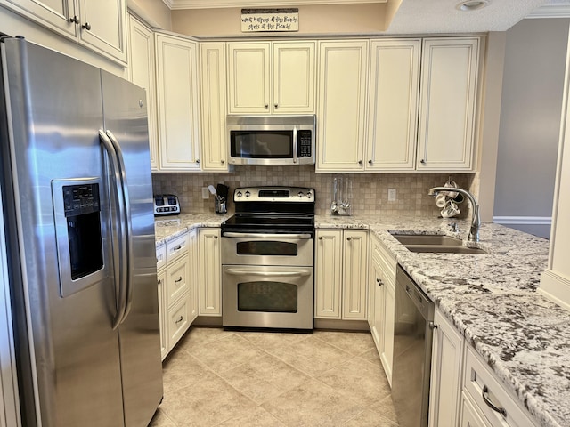 kitchen featuring stainless steel appliances, backsplash, crown molding, and a sink