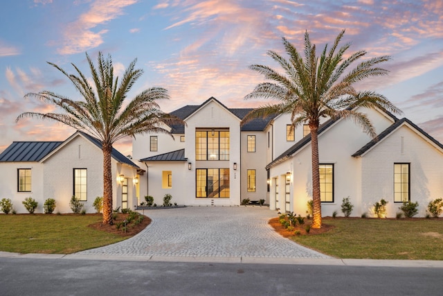 724 Windsong Dr, Inlet Beach, FL 32461 - view of front of property featuring a garage, a standing seam roof, decorative driveway, and metal roof