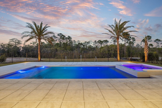 724 Windsong Dr, Inlet Beach, FL 32461 - pool at dusk with a pool with connected hot tub and fence