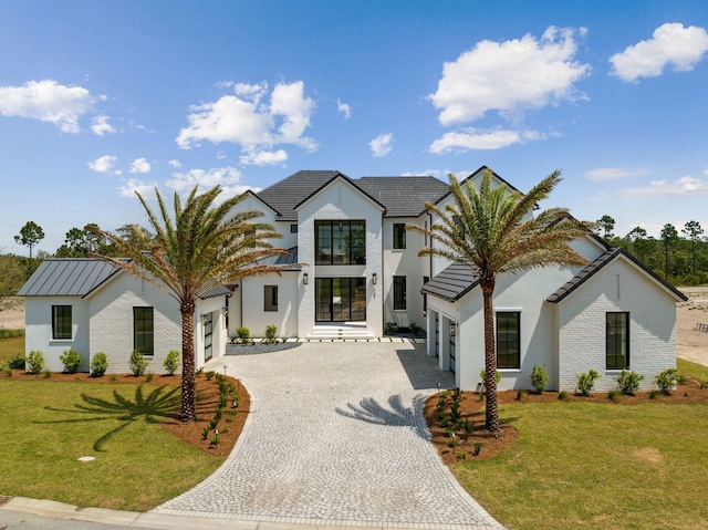 724 Windsong Dr, Inlet Beach, FL 32461 - view of front of house with a tile roof, a front lawn, a garage, stucco siding, and decorative driveway