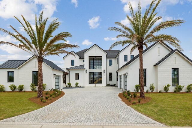 724 Windsong Dr, Inlet Beach, FL 32461 - modern farmhouse style home featuring a garage, a standing seam roof, decorative driveway, a front yard, and metal roof