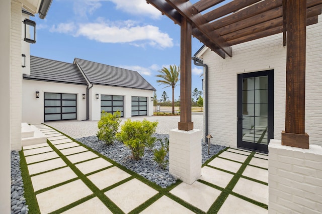 724 Windsong Dr, Inlet Beach, FL 32461 - view of patio / terrace with a pergola, driveway, and a garage