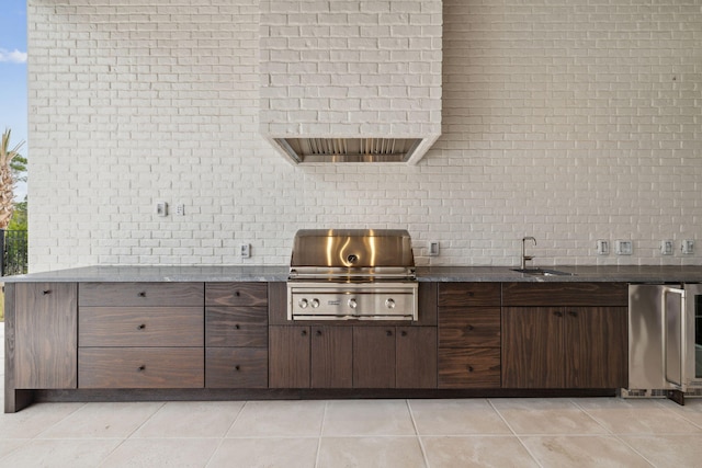 724 Windsong Dr, Inlet Beach, FL 32461 - kitchen featuring a sink, light tile patterned flooring, dark brown cabinetry, refrigerator, and decorative backsplash
