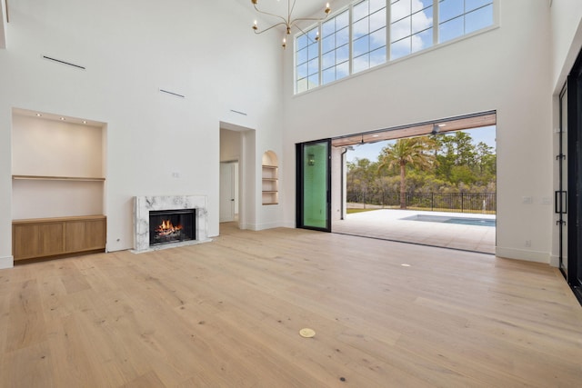 724 Windsong Dr, Inlet Beach, FL 32461 - unfurnished living room with a high ceiling, a healthy amount of sunlight, and wood finished floors