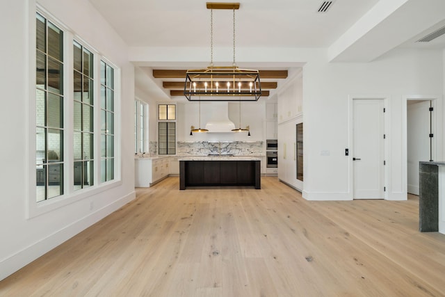724 Windsong Dr, Inlet Beach, FL 32461 - kitchen featuring an inviting chandelier, light countertops, decorative backsplash, light wood-style flooring, and white cabinetry