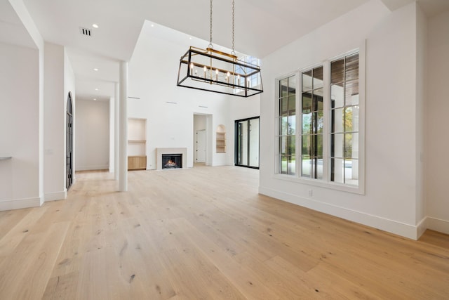 724 Windsong Dr, Inlet Beach, FL 32461 - unfurnished living room with a chandelier, light wood-style flooring, baseboards, visible vents, and recessed lighting