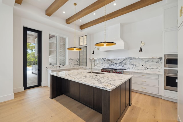 724 Windsong Dr, Inlet Beach, FL 32461 - kitchen with a sink, stainless steel oven, backsplash, beamed ceiling, and an island with sink