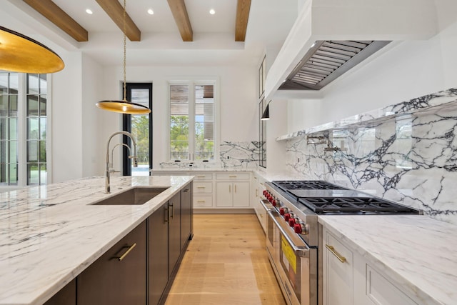 724 Windsong Dr, Inlet Beach, FL 32461 - kitchen with a sink, beamed ceiling, light wood finished floors, double oven range, and custom range hood