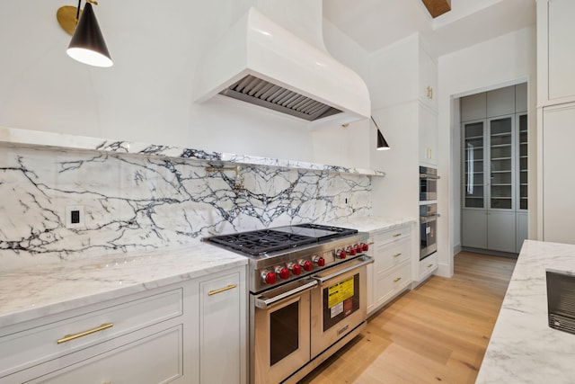 724 Windsong Dr, Inlet Beach, FL 32461 - kitchen featuring custom exhaust hood, decorative backsplash, light wood-style floors, stainless steel appliances, and white cabinets